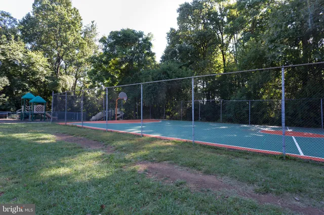 a view of a yard with basketball court