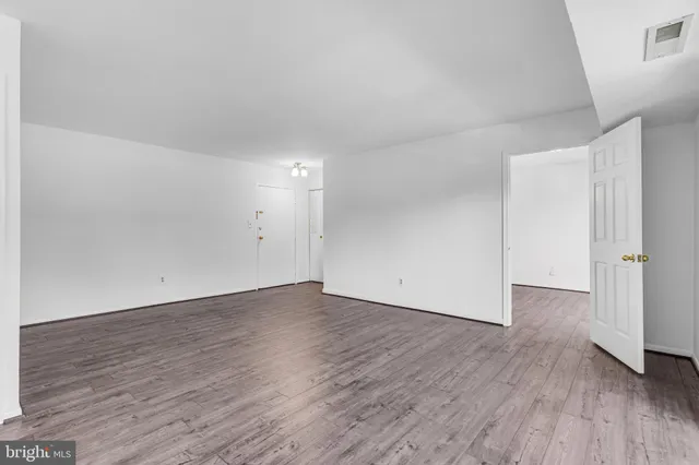 an empty room with wooden floor