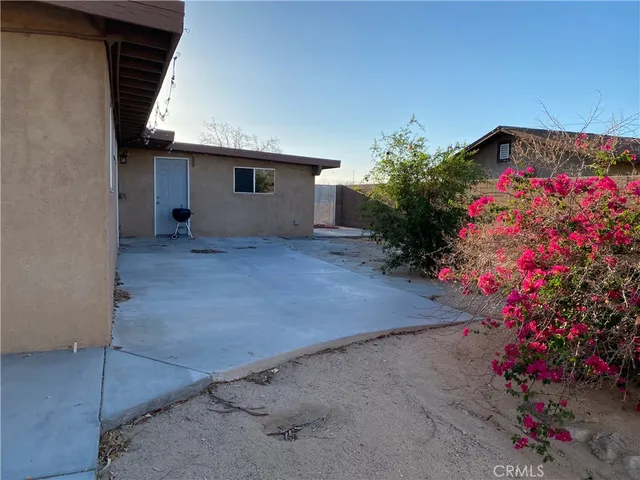 a backyard of a house with flower plants
