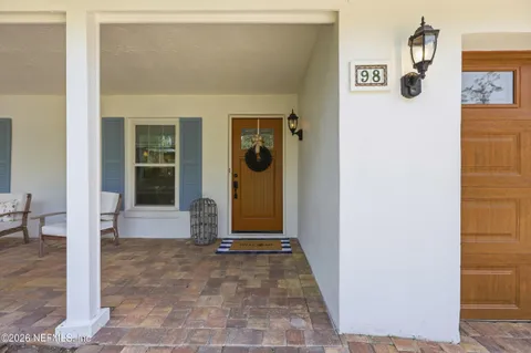 a view of a hallway with wooden floor and dining room