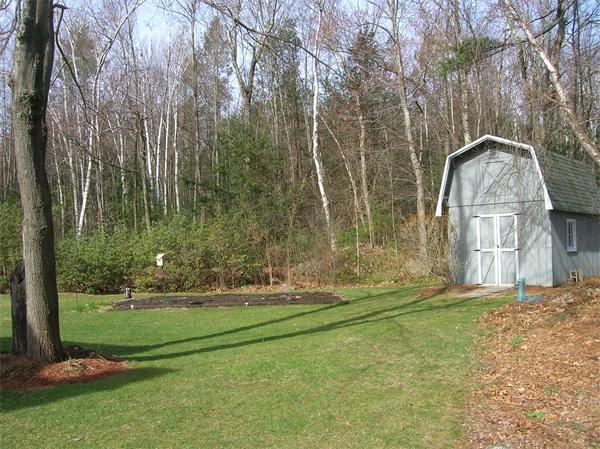 22 Esty Road Princeton, MA 01541 - Photo 23 of 25 a backyard of a house with lots of green space and fountain
