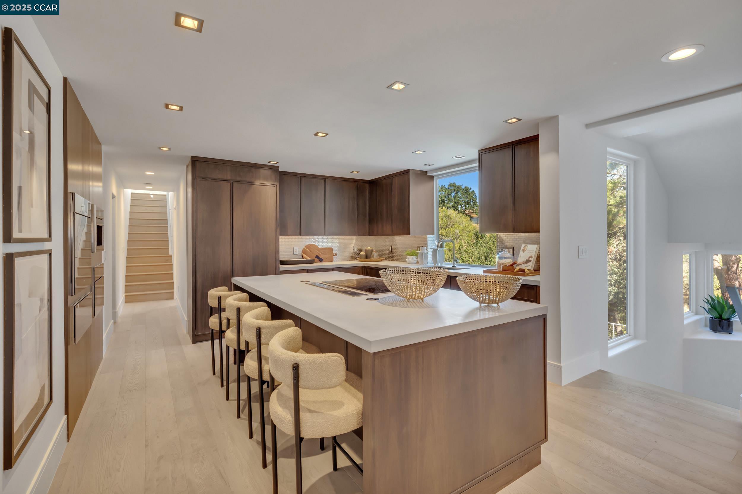 127 Caminar Way Walnut Creek, CA 94596 - Photo 11 of 60 a kitchen with stainless steel appliances kitchen island a table chairs sink and refrigerator