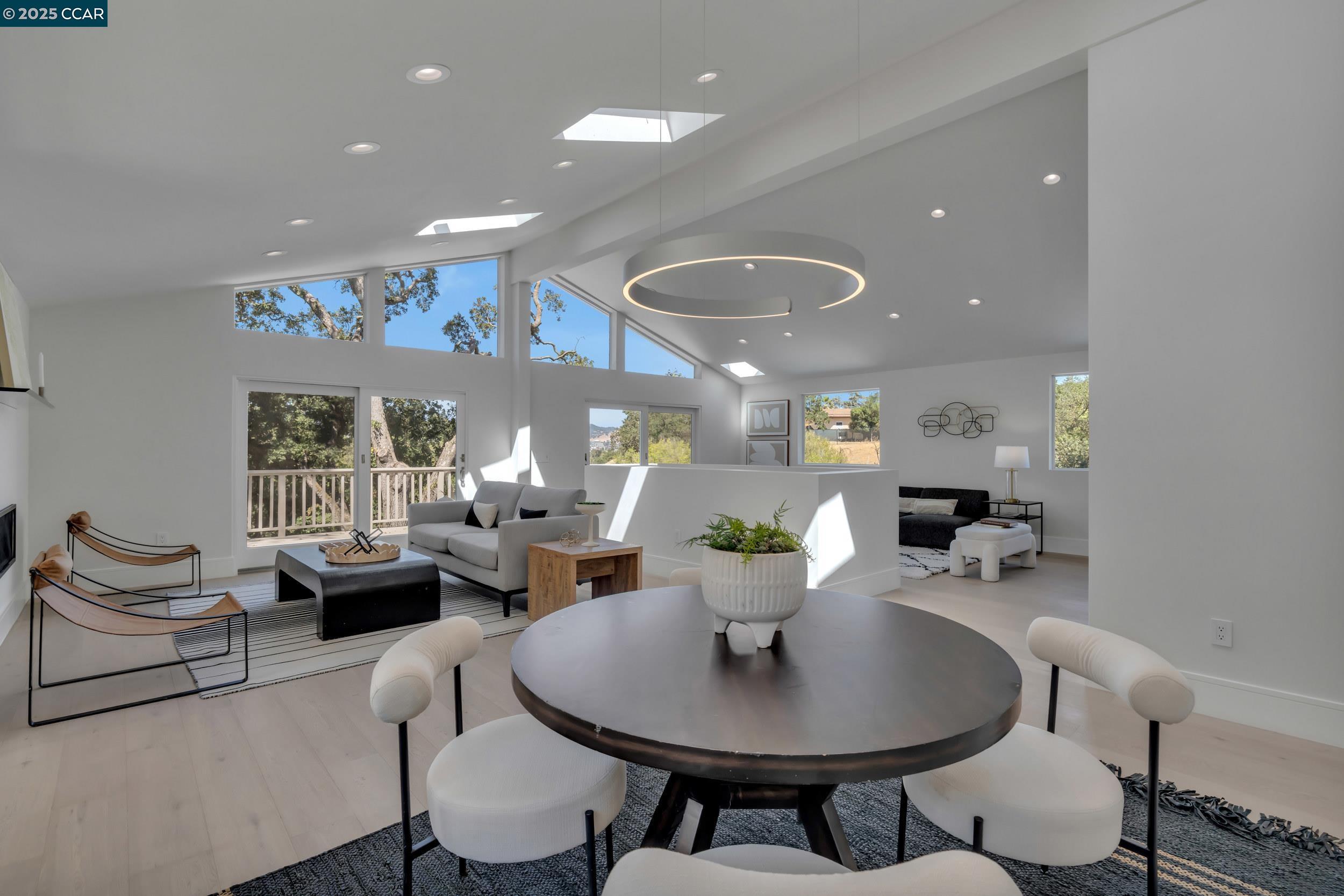 127 Caminar Way Walnut Creek, CA 94596 - Photo 16 of 60 a living room with furniture kitchen view and a chandelier