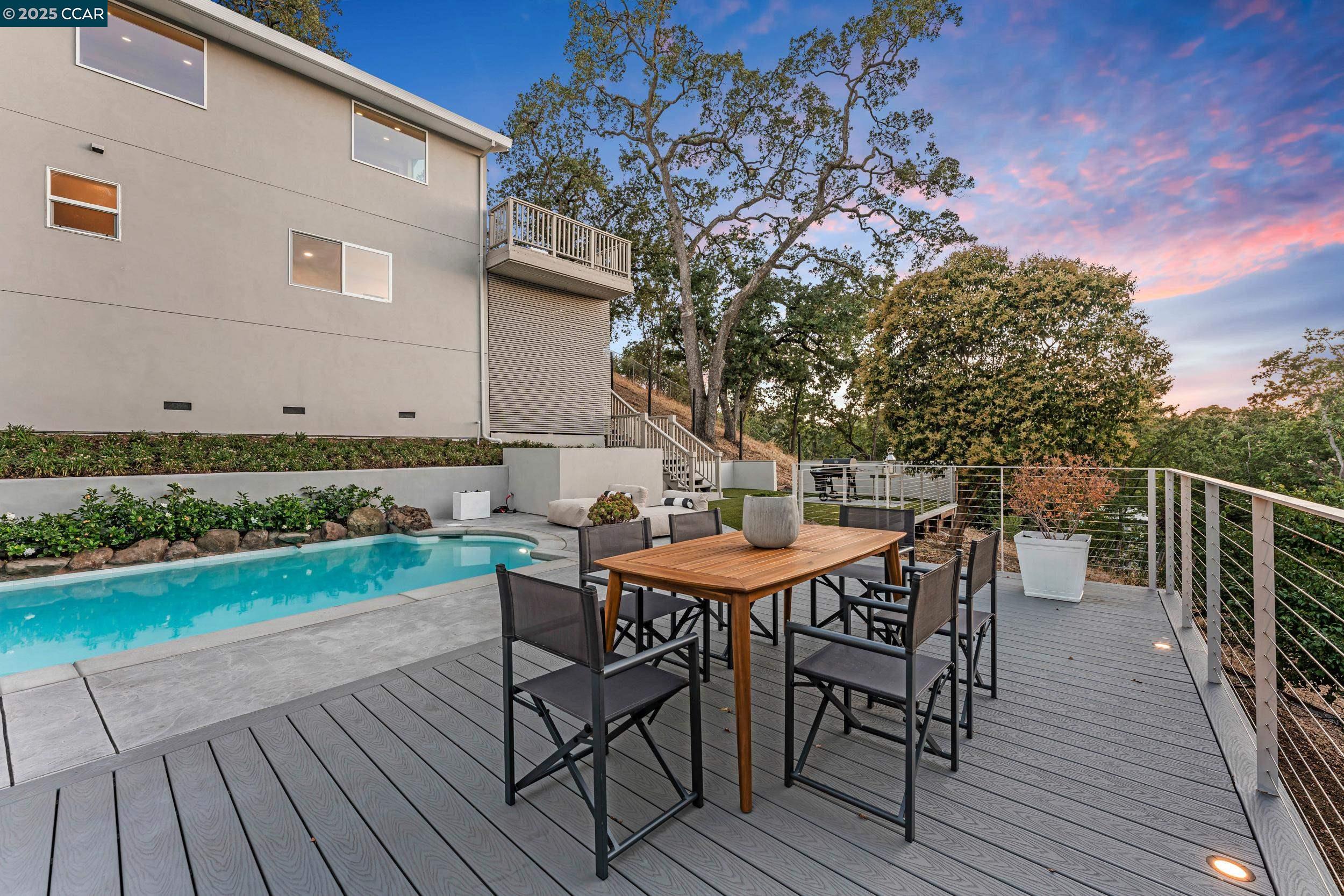 127 Caminar Way Walnut Creek, CA 94596 - Photo 49 of 60 a view of a roof deck with table and chairs with wooden floor and fence