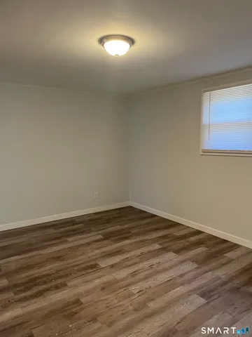 a view of an empty room and wooden floor