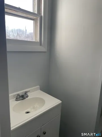 a bathroom with a sink and a window