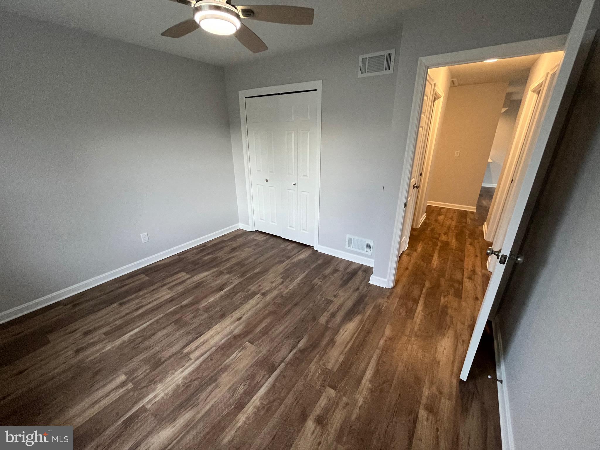 3077 Lakefield Road, Unit 3077 York, PA 17402 - Photo 15 of 33 a view of an empty room with wooden floor and a window