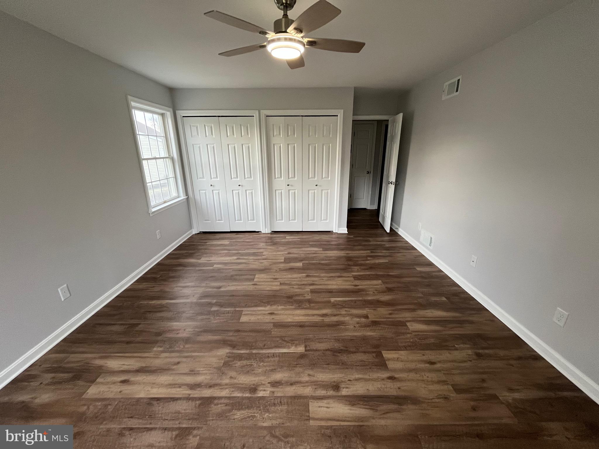 3077 Lakefield Road, Unit 3077 York, PA 17402 - Photo 16 of 33 a view of an empty room with wooden floor and a window