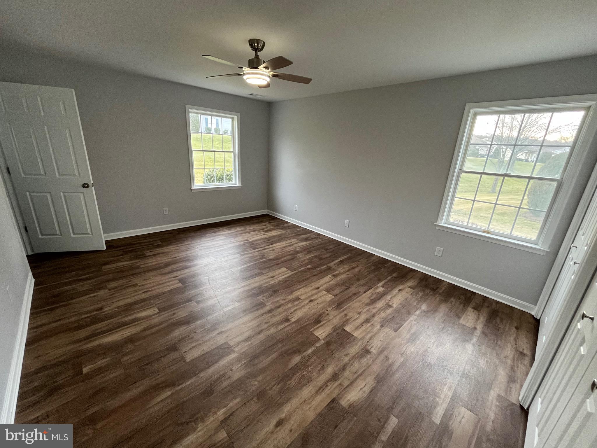 3077 Lakefield Road, Unit 3077 York, PA 17402 - Photo 18 of 33 a view of an empty room with wooden floor and a window