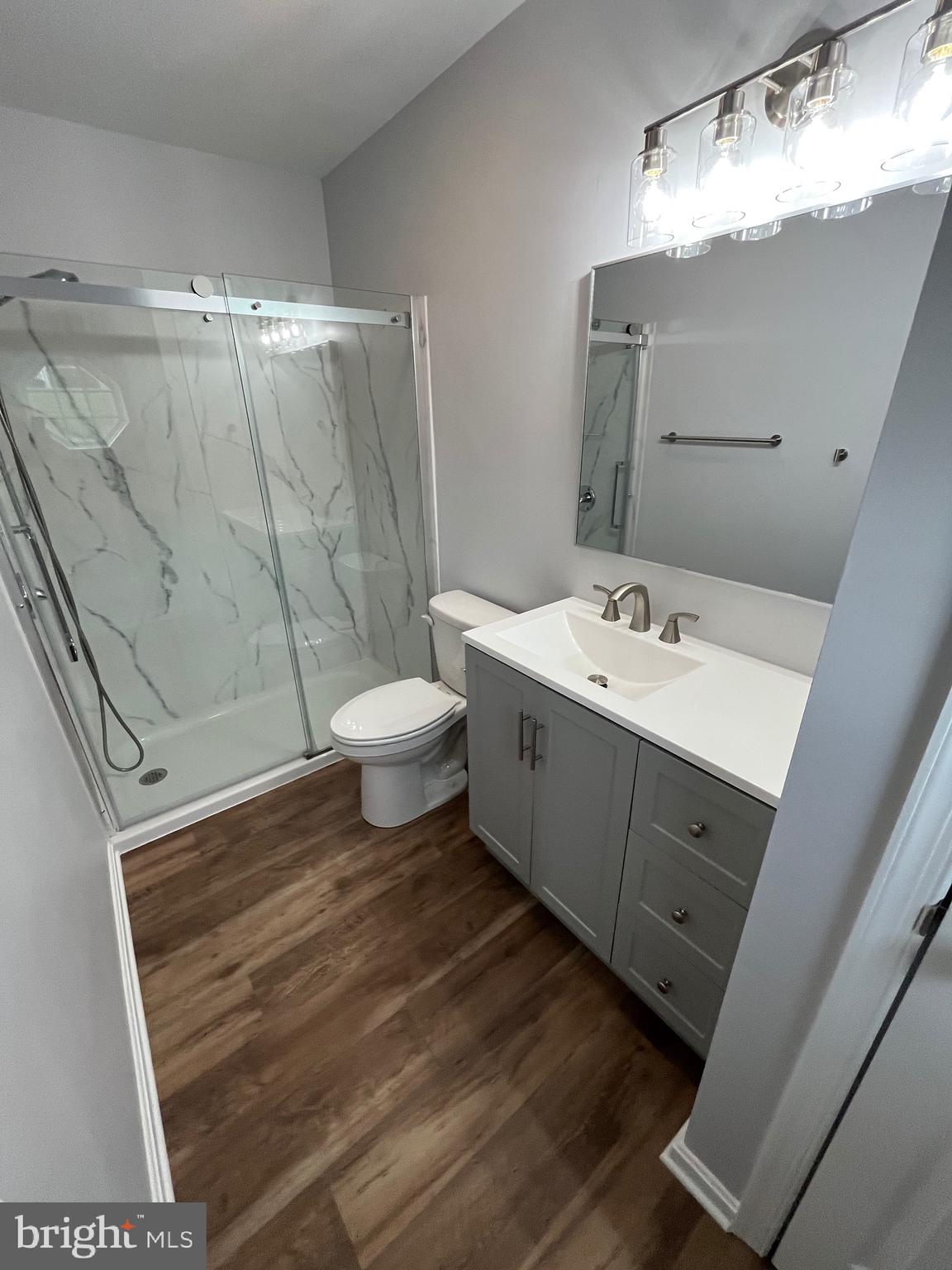 3077 Lakefield Road, Unit 3077 York, PA 17402 - Photo 19 of 33 a bathroom with a sink mirror vanity and toilet