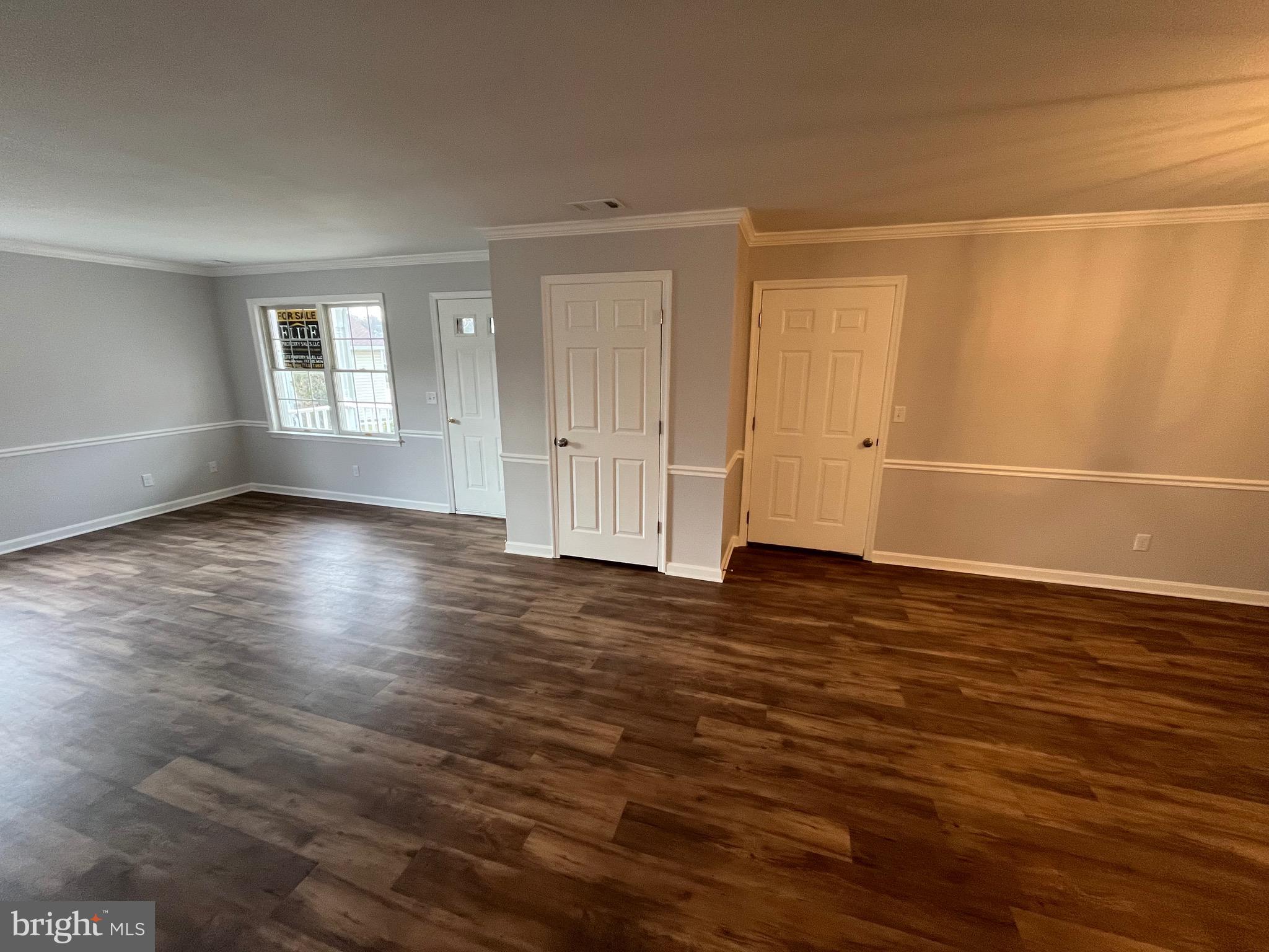 3077 Lakefield Road, Unit 3077 York, PA 17402 - Photo 24 of 33 a view of an empty room with wooden floor and a window