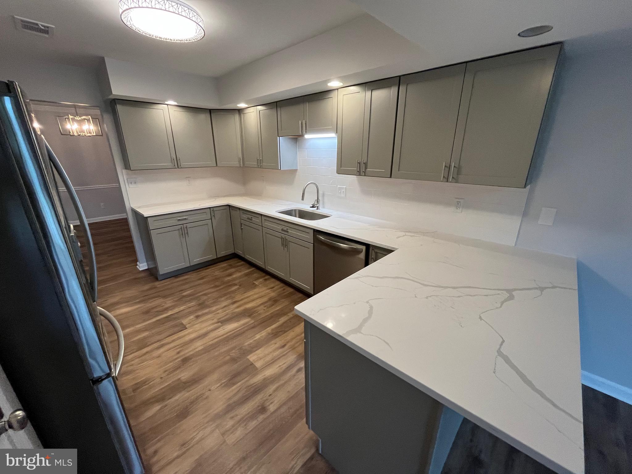 3077 Lakefield Road, Unit 3077 York, PA 17402 - Photo 5 of 33 a kitchen with a sink a refrigerator and cabinets