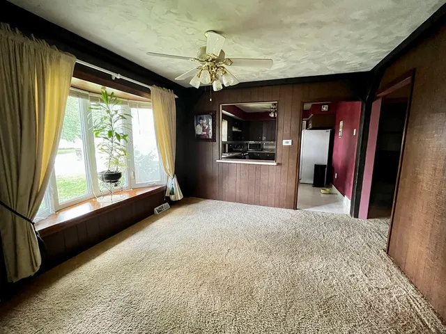 a view of empty room with a kitchen appliances and a large window