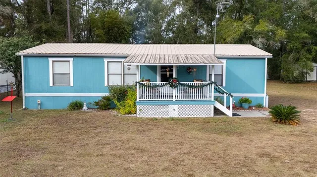 a front view of a house with a garden and porch