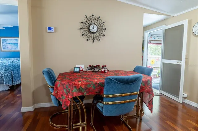 a kitchen with stainless steel appliances granite countertop a refrigerator a sink dishwasher a stove with wooden cabinets and floor