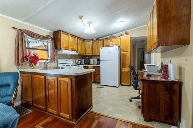 a kitchen with stainless steel appliances a refrigerator sink and cabinets