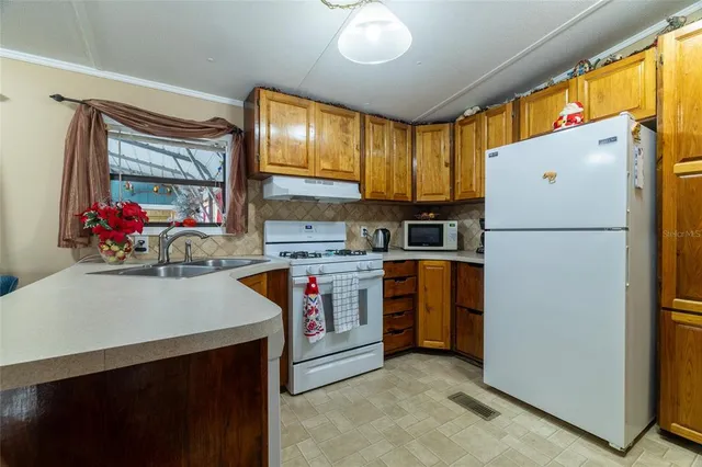 a open kitchen with stainless steel appliances granite countertop a stove and a refrigerator