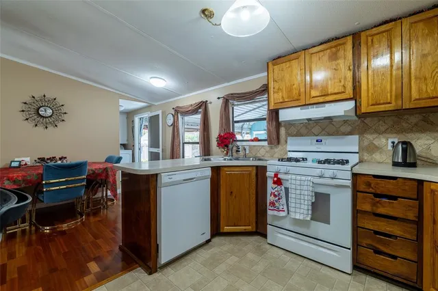 a kitchen with a sink cabinets and a large window