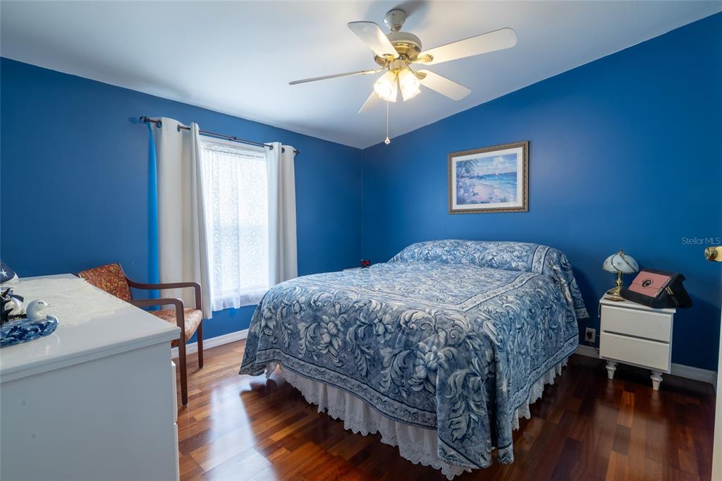 591 Marshburn Drive Bronson, FL 32621 - Photo 27 of 69 a bedroom with a bed and a chandelier