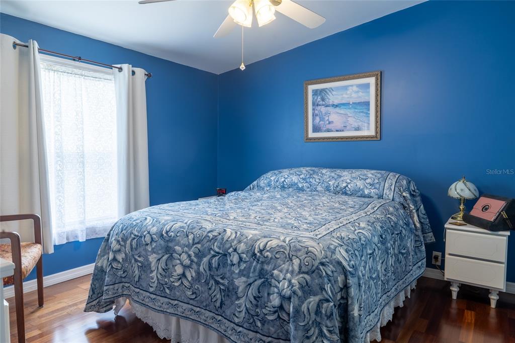 591 Marshburn Drive Bronson, FL 32621 - Photo 28 of 69 a bedroom with a bed and a chandelier