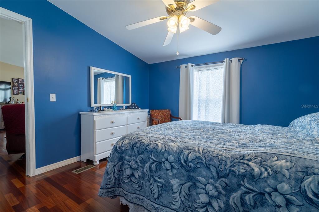 591 Marshburn Drive Bronson, FL 32621 - Photo 29 of 69 a bedroom with a bed and a chandelier
