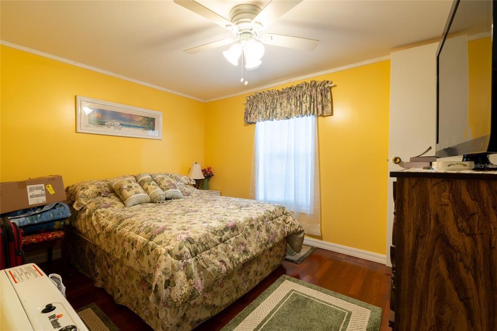 591 Marshburn Drive Bronson, FL 32621 - Photo 42 of 69 a bedroom with a bed and a chandelier