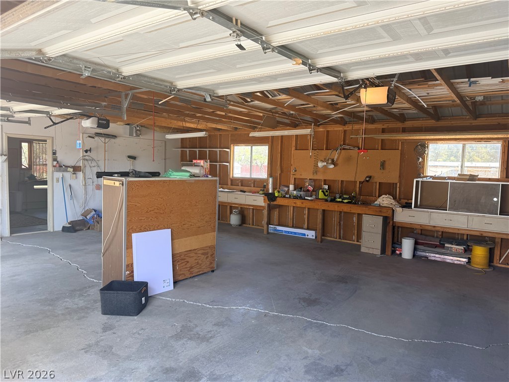 1391 West Dyer Road Pahrump, NV 89048 - Photo 15 of 50 Ample workshop space and durable concrete flooring define this practical garage.