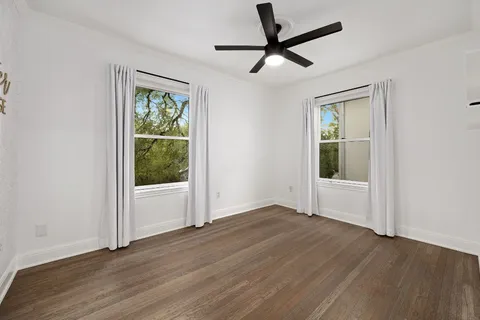 a bathroom with a granite countertop sink a toilet and a mirror