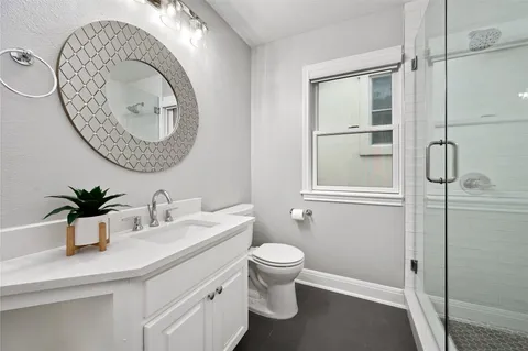 a view of a green field with wooden fence