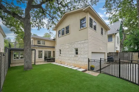 a view of a backyard with wooden fence