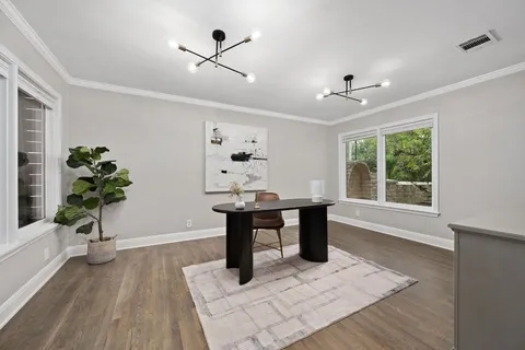 a kitchen with stainless steel appliances a white table chairs and a refrigerator