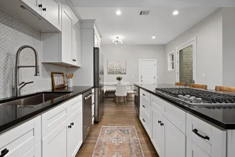 a kitchen with a table and chairs in it
