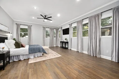 a bedroom with a bed and wooden floor