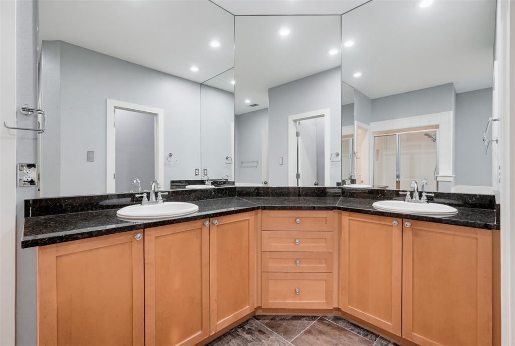 4830 Cedar Springs Road, Unit 30 Dallas, TX 75219 - Photo 26 of 32 Bathroom vanity featuring dual under-mount sinks set into a dark granite countertop
