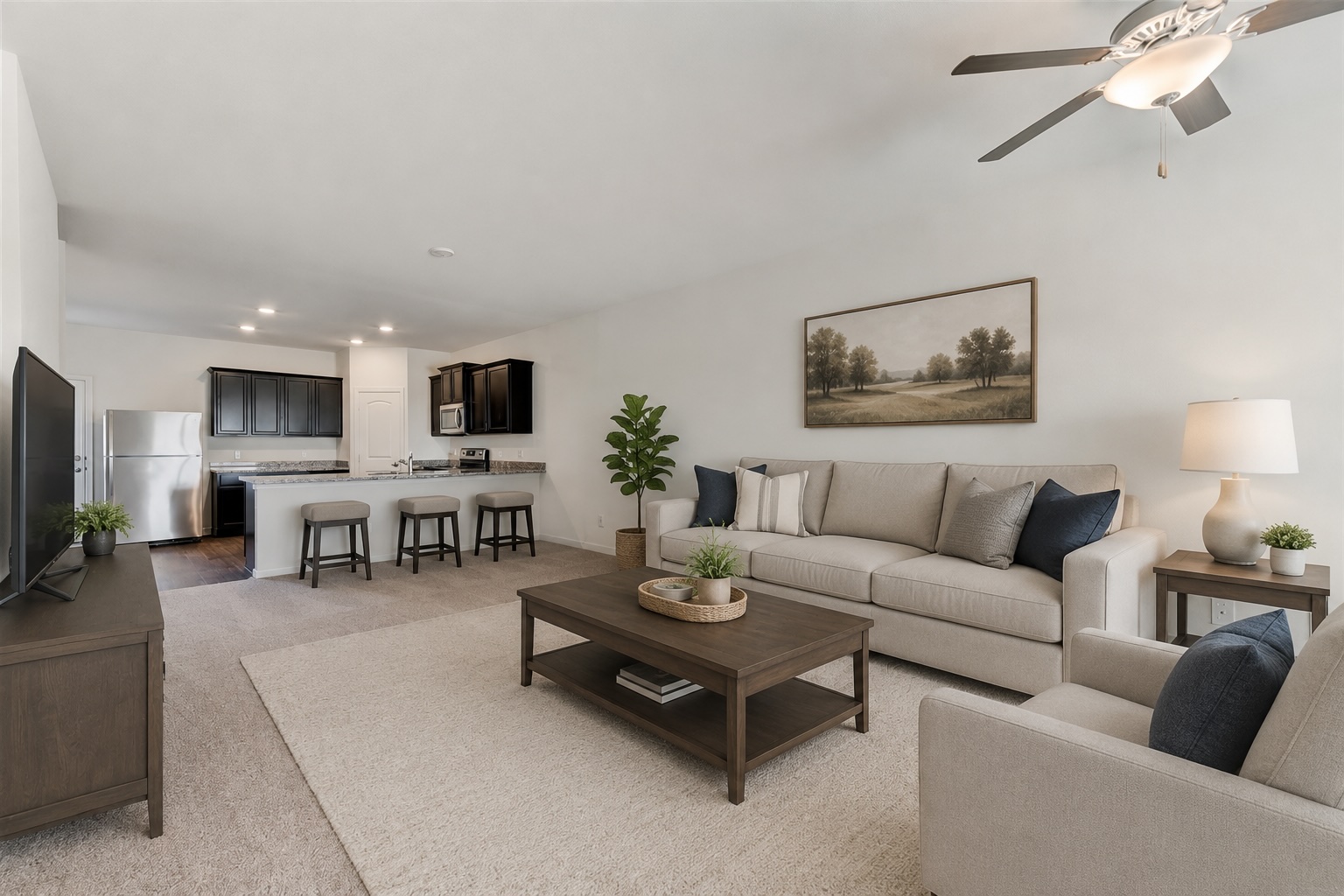 105 Brunswick Lane Jarrell, TX 76537 - Photo 3 of 18 a living room with furniture a flat screen tv and kitchen view