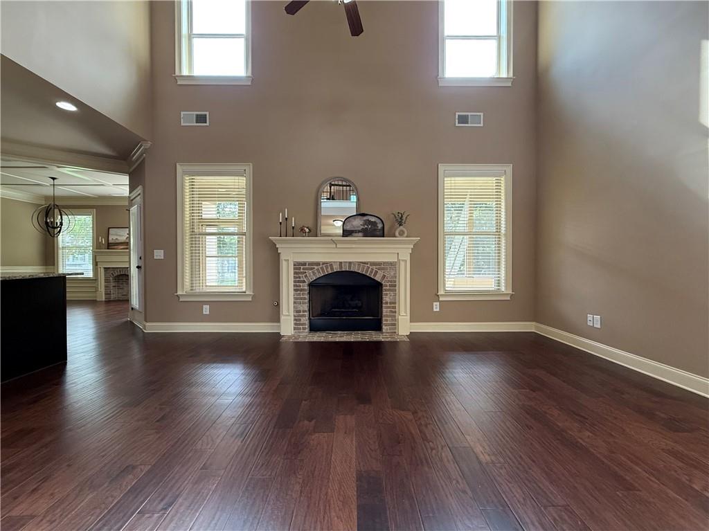 4662 Whitlow Ridge Drive Bishop, GA 30621 - Photo 17 of 70 an empty room with wooden floor a fireplace and windows