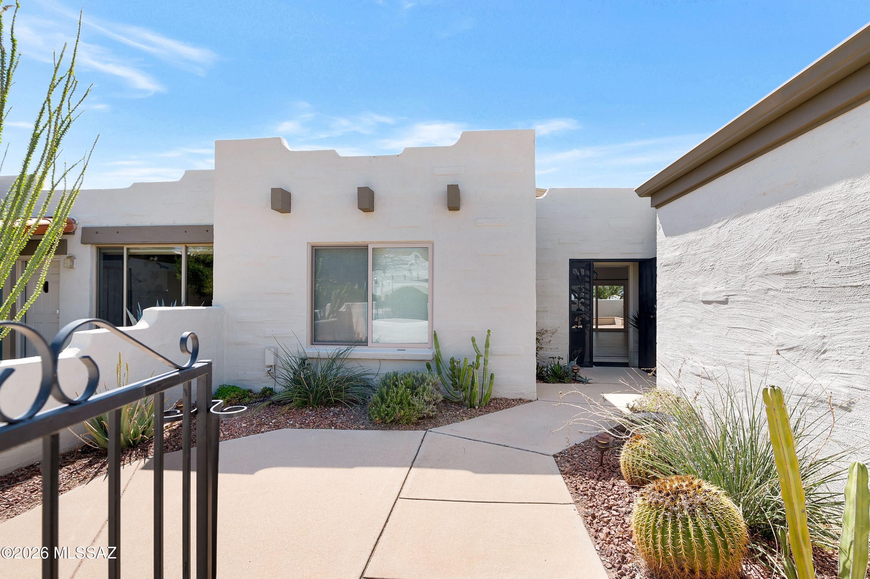 7408 East Wandering Road Tucson, AZ 85750 - Photo 2 of 25 a front view of a house with garden