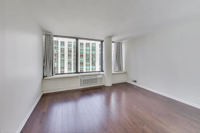 a view of an empty room and wooden floor