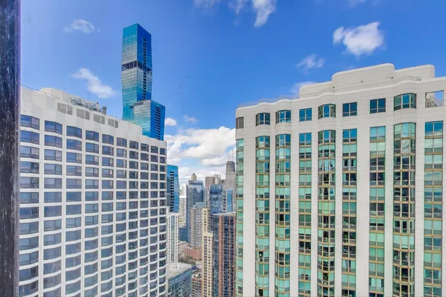 a kitchen with stainless steel appliances white cabinets and a stove top oven