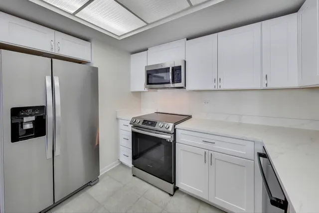 a kitchen with stainless steel appliances a refrigerator and a stove