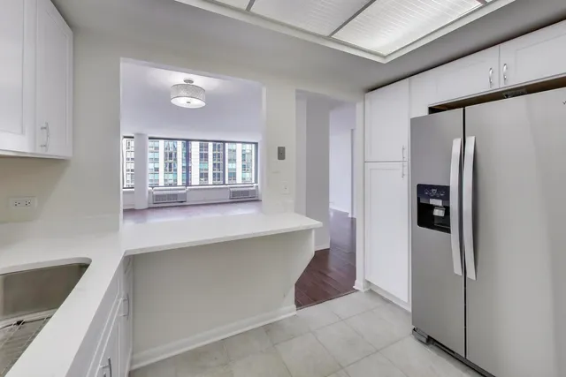 a bathroom with a granite countertop sink mirror and toilet