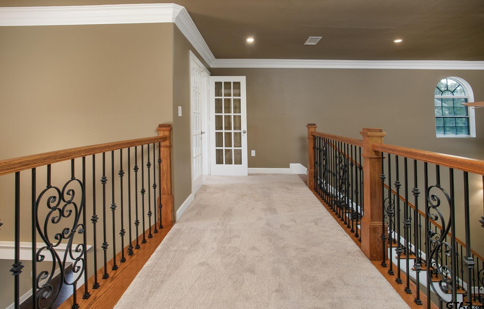 18722 Ridgeline Road Tyler, TX 75703 - Photo 27 of 47 Upstairs hallway is a balcony with views down to the living area and front entry.