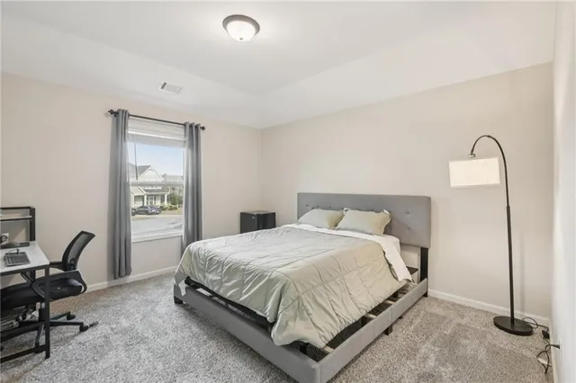 a bedroom with a bed a desk and chair