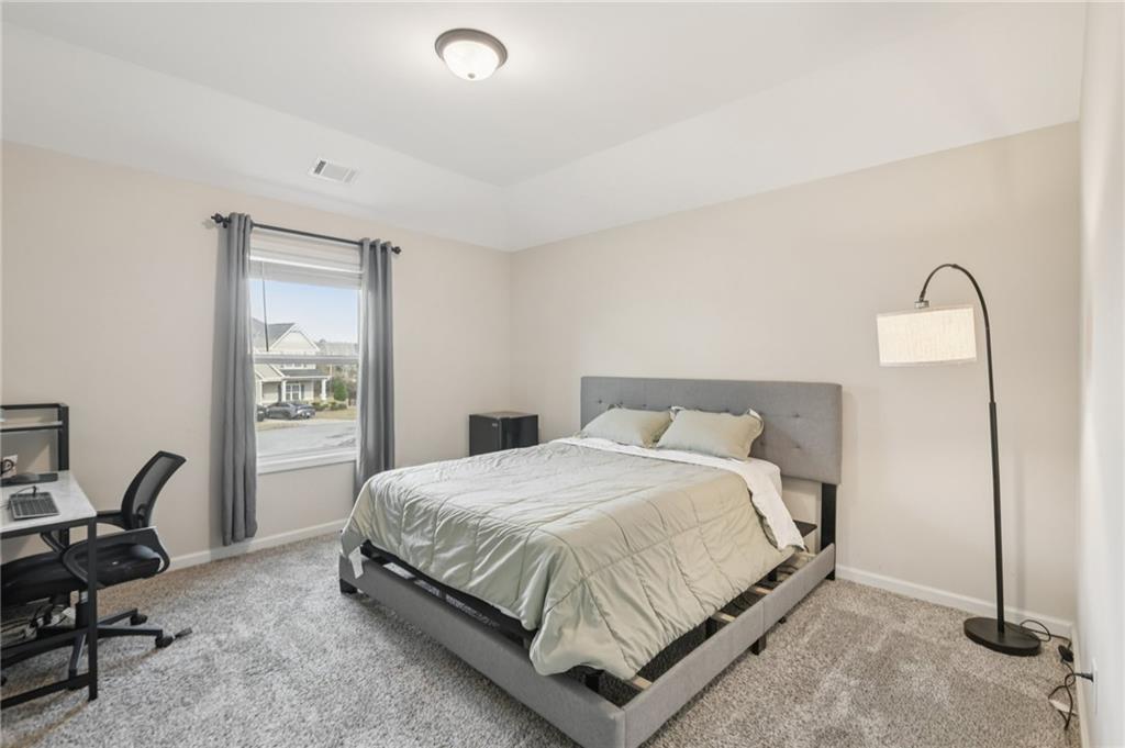 1120 Red Bud Circle Villa Rica, GA 30180 - Photo 19 of 31 a bedroom with a bed a desk and chair