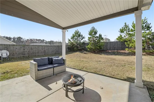 a view of roof deck with couches and wooden floor