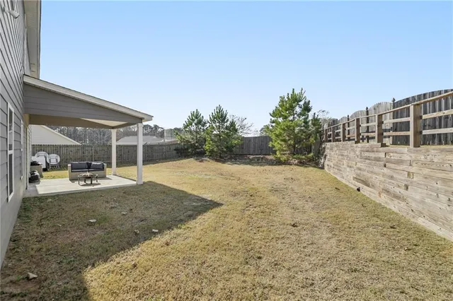 a view of backyard with large trees