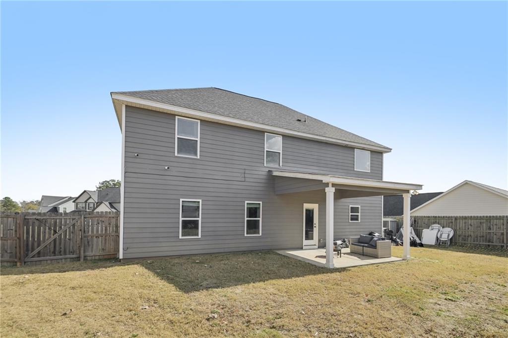 1120 Red Bud Circle Villa Rica, GA 30180 - Photo 25 of 31 a front view of a house with a yard and garage