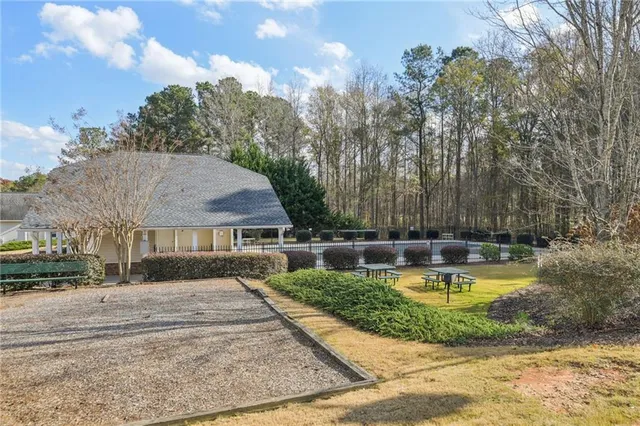 a view of a house with swimming pool and a yard