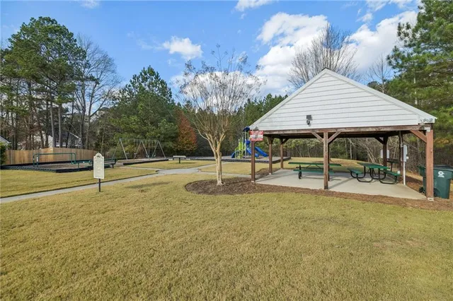 a backyard of a house with table and chairs