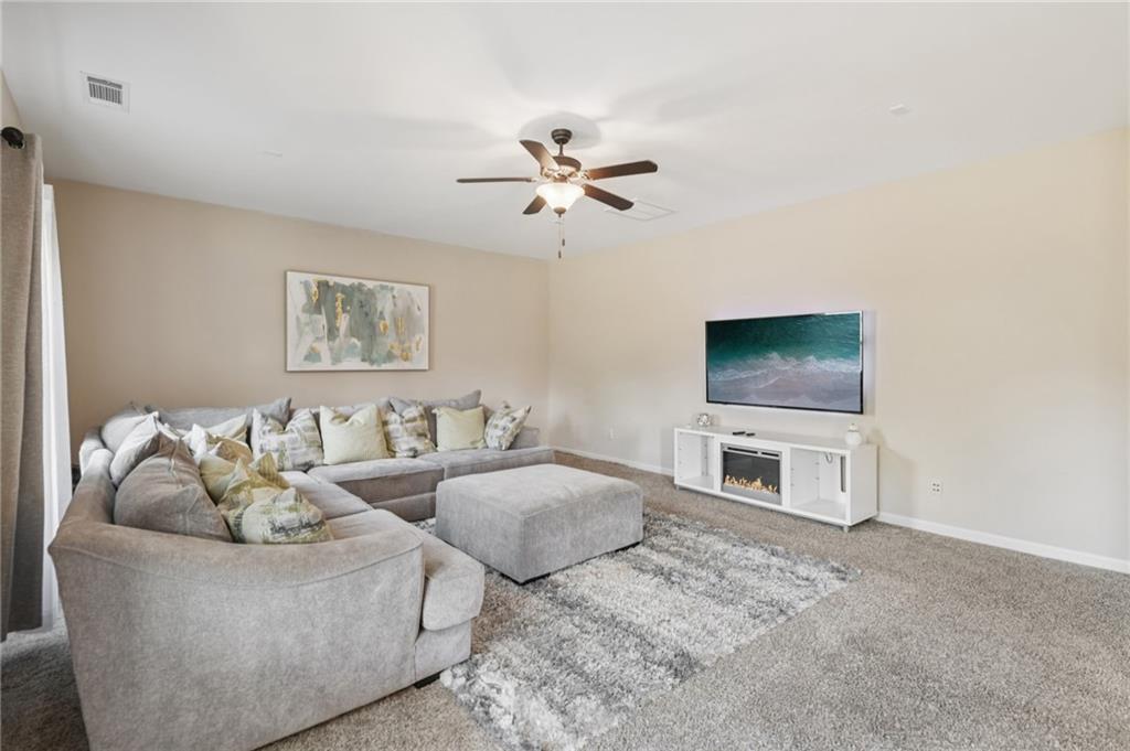 1120 Red Bud Circle Villa Rica, GA 30180 - Photo 5 of 31 a living room with furniture and a flat screen tv